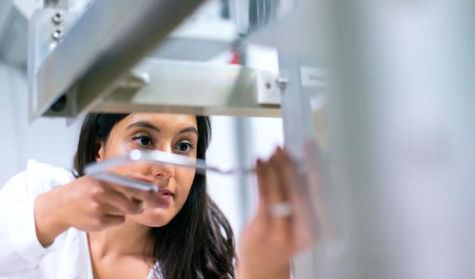 Close up of a woman engineer examining technical equipment