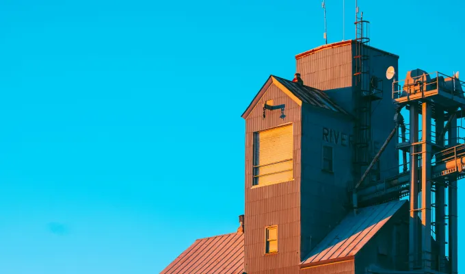 Photo of a grain elevator against a blue sky