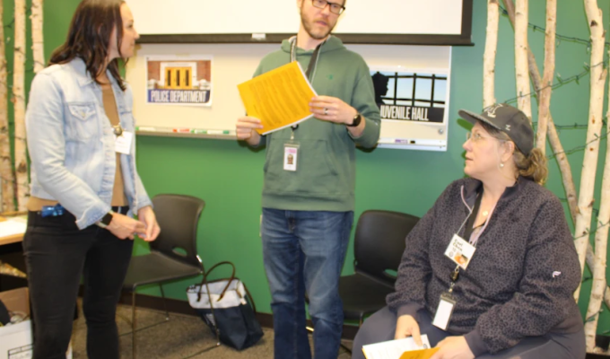 Photo of three people role playing in a poverty simulation