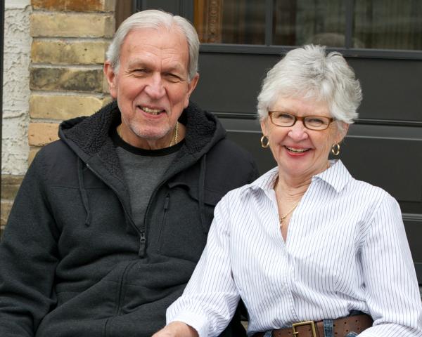 Older couple sitting on front step
