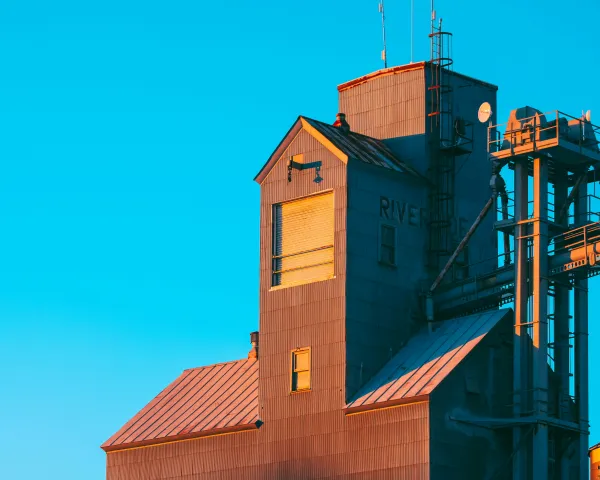 Photo of a grain elevator against a blue sky
