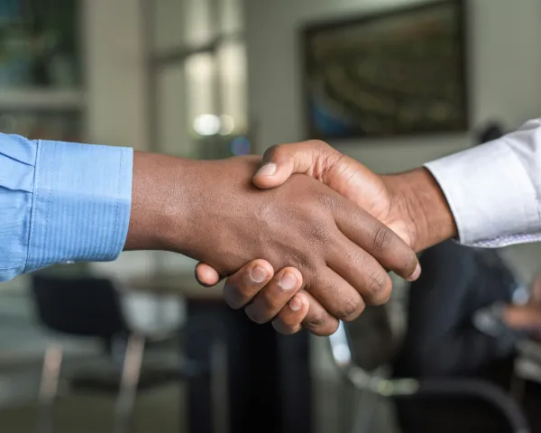 Close up photo of two hands in a handshake