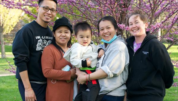 Asian family in front of a flowering crab apple tree