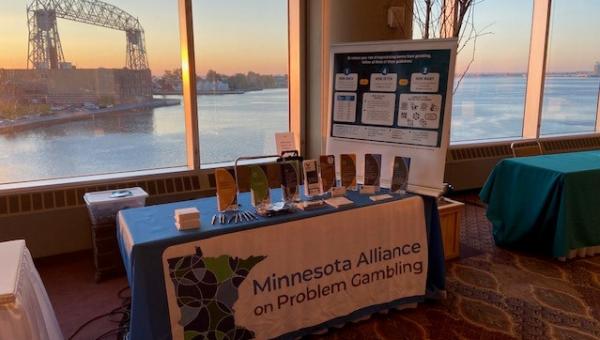 Photo of MNAPG exhibit booth with Duluth lift bridge in background