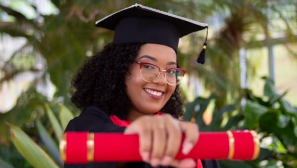 Photo of Black Woman graduate with diploma. Photo by Felipe Gregate on Unsplash