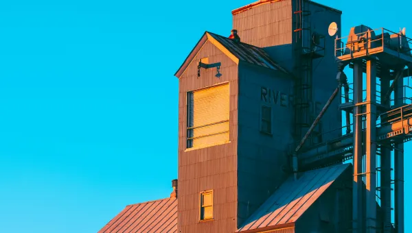 Photo of a grain elevator against a blue sky